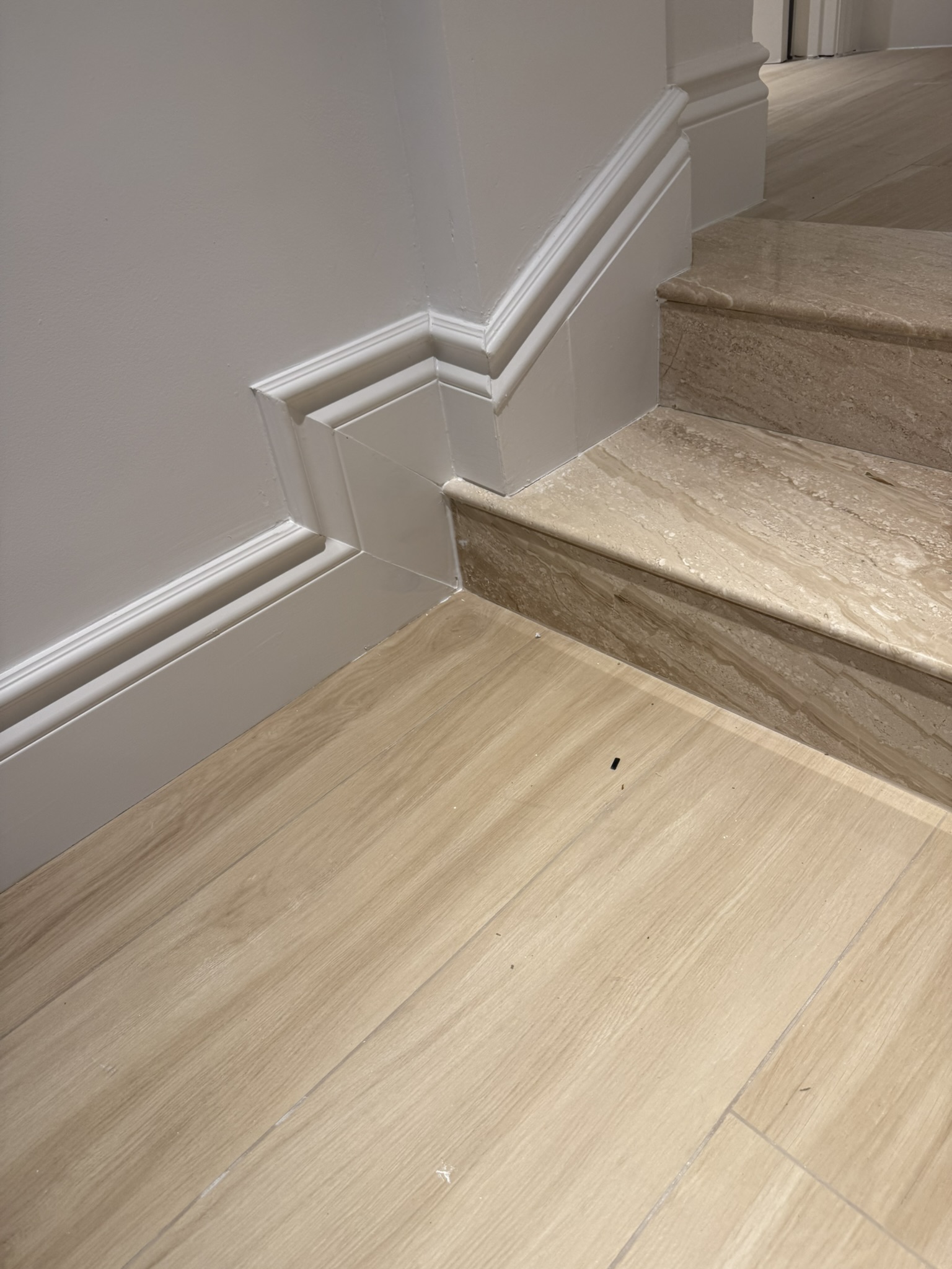 Finished baseboard around stairs