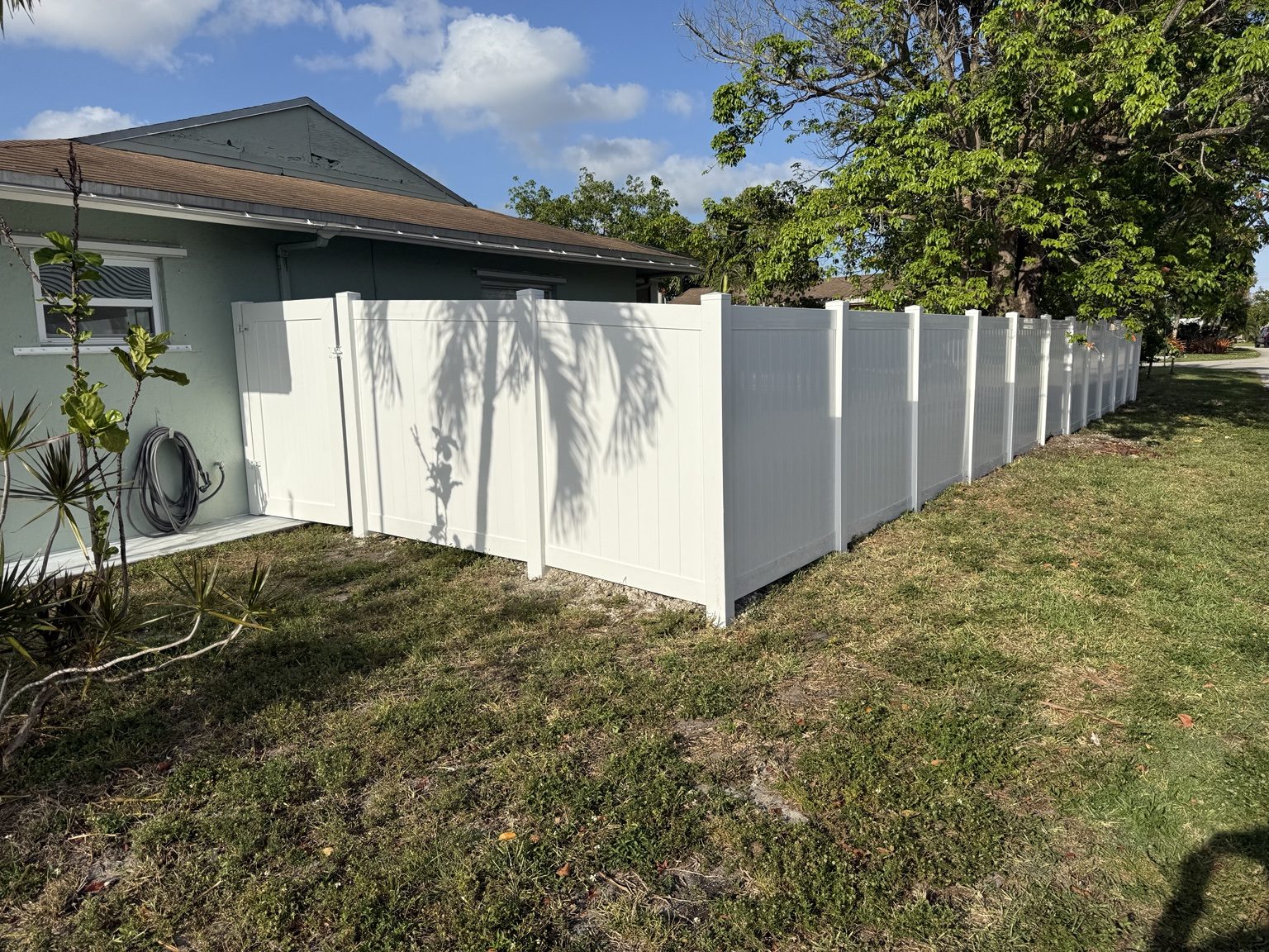 Vinyl privacy fence beside home