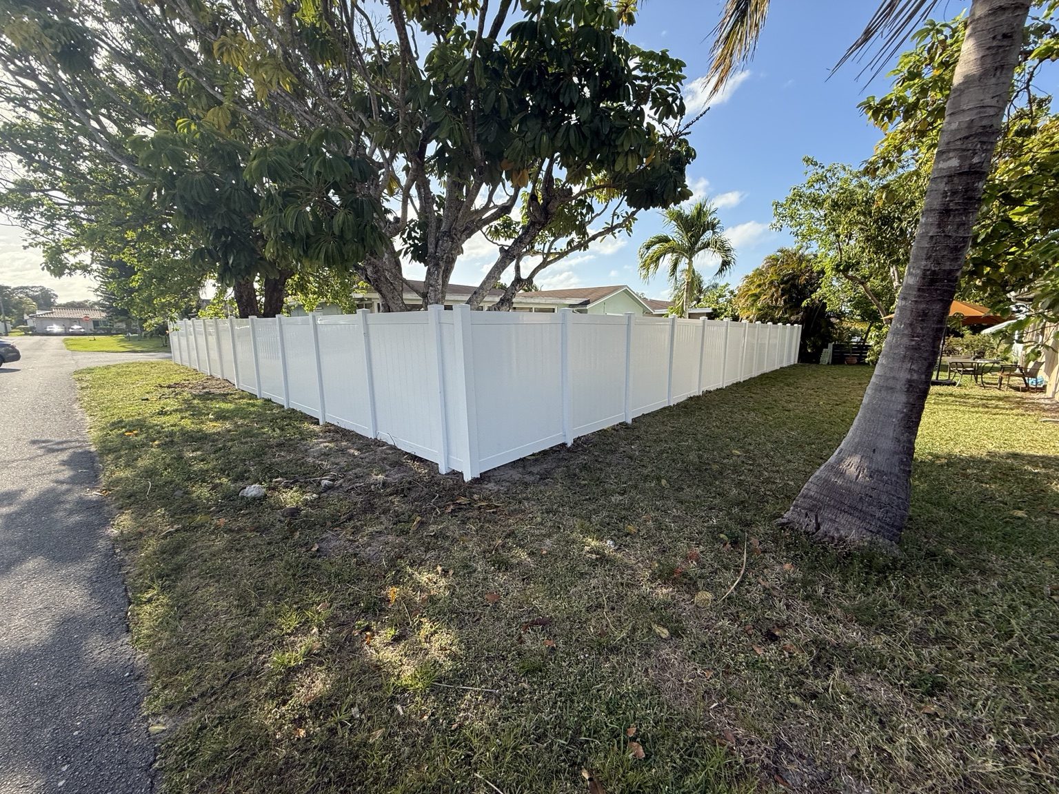 Completed white vinyl privacy fence